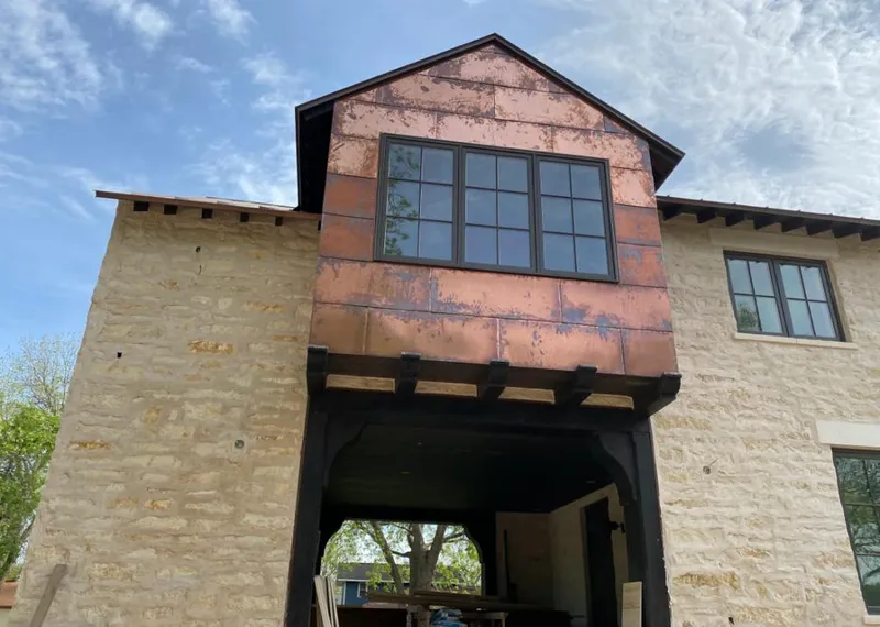 Copper metal panel facade on a stone building for Roof Repair in Franklin Lakes