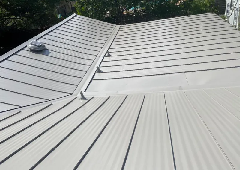 Solar attic fan installed on a metal roof for Roof Ventilation in Franklin Lakes